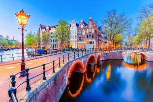 Amsterdam Netherlands dancing houses over river Amstel landmark in old european city spring landscape.