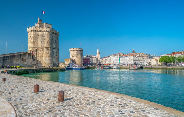 Photo of La Rochelle, France old harbour with medieval castle towers on Atlantic coast of Charente-Maritime.