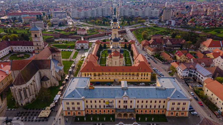 photo of view of Aerial view of the Alba Carolina citadel located in Alba Iulia, Romania. In the photography can be seen the Reunification Cathedral from above, shot from a drone with camera tilted down for a top view