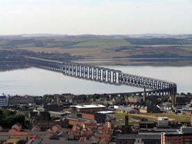 Photo of aerial view of Aberdeen as River Dee flows in a curve to the North Sea showing Duthie Park with bridge and traffic from south.