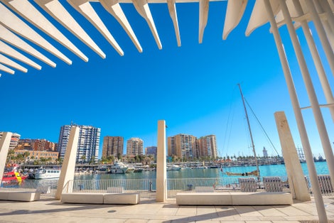 Photo of Waterfront of Palmeral de las sorpresa promenade at port in Malaga. Andalusia, Spain .
