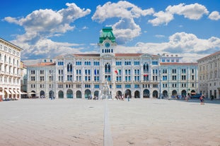 Photo of Italy Piazza Maggiore in Bologna old town tower of town hall with big clock and blue sky on background, antique buildings terracotta galleries.