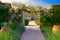 Photo of British Garden tunnel with lilac flowers lane in the Lost gardens of Heligan in Cornwall, UK.