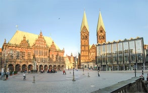 Photo of beautiful panoramic view of historic Bremen Market Square in the center of the Hanseatic City of Bremen with The Schuetting and famous Raths buildings on a sunny day with blue sky in summer, Germany.