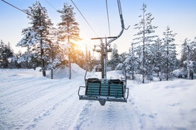 Photo of stunning sunset view over wooden huts and snow covered trees in Kuusamo, Finnish Lapland.