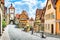 Photo of beautiful postcard view of the famous historic town of Rothenburg ob der Tauber on a sunny day with blue sky and clouds in summer, Franconia, Bavaria, Germany.