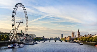 London, England - Panoramic skyline view of Bank and Canary Wharf, central London's leading financial districts with famous skyscrapers at golden hour sunset with blue sky and clouds.