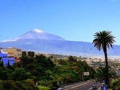 Photo of aerial view with Puerto de la Cruz, in background Teide volcano, Tenerife island, Spain.