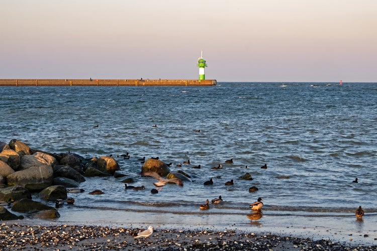 photo of view of View over the Baltic Sea to the lighthouse of Travemünde, Lübeck, Germany.