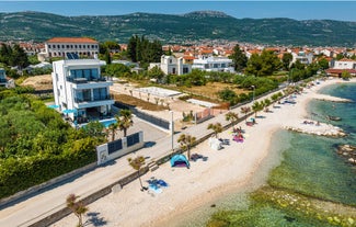 photo of a beautiful panoramic view of Kastel Luksic harbor and landmarks summer view, Split region of Dalmatia, Croatia.