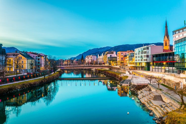 view of a riverside of river Drau during sunset in Villach, Austria