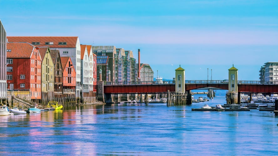 The view of the bridge Bakke Bru, the river Nidelva and historical old timber buildings in Trondheim, Norway.