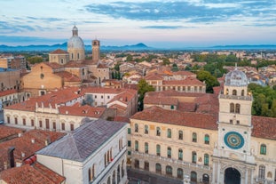 Photo of aerial view of Verona historical city centre, Ponte Pietra bridge across Adige river, Verona Cathedral, Duomo di Verona, red tiled roofs, Veneto Region, Italy.