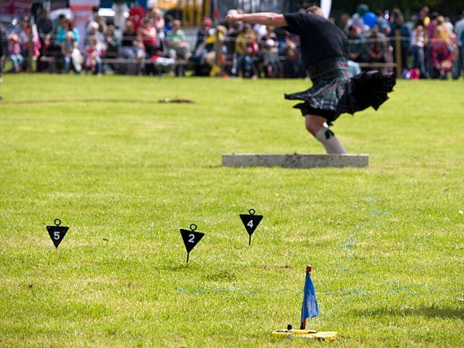 A competitor preparing to throw the heavy stone in the traditional -Stone Put- event during the Scottish Highland Games.jpg