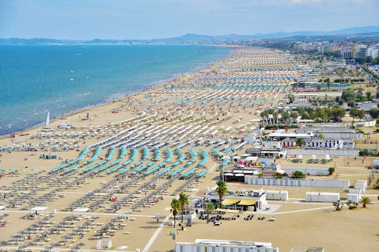 Bay and seafront of Rimini and Riccione with umbrellas in summer
