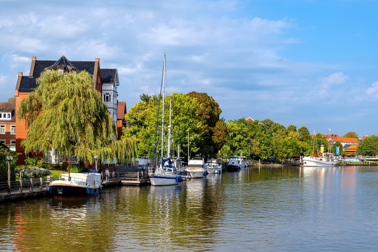 Photo of river Ems with ships and buildings in Leer, East Frisia ,Lower Saxony, Germany.