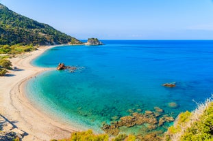 Photo of aerial view of Pythagorio port with colourful houses and blue sea, Samos island, Greece.