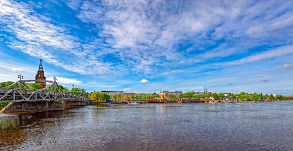 Porin silta the Pori Bridge (1926) crossing Kokemanjoki river and Neogothic style Central Lutheran Churchin in Pori, Finland