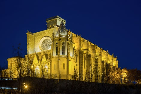 Photo of Basilica of Santa Maria de la Seu with evening lights in Manresa, Spain.