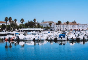 Photo of wide sandy beach in white city of Albufeira, Algarve, Portugal.