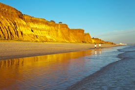 Photo of wide sandy beach in white city of Albufeira, Algarve, Portugal.