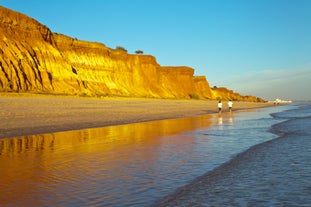 Photo of wide sandy beach in white city of Albufeira, Algarve, Portugal.