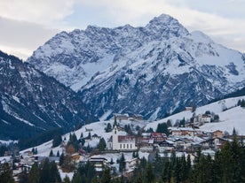 photo of village of Hirschegg in the Kleinwalsertal, Vorarlberg, Austria, with Gottesackerplateau in the background.