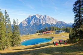 Photo of aerial view of the city of Lermoos, Austria with the Alps mountains in the background on a sunny summer day.