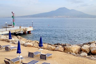 Naples, Italy. View of the Gulf of Naples from the Posillipo hill with Mount Vesuvius far in the background and some pine trees in foreground.