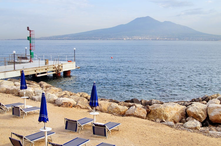 Sandy beach overlooking the Gulf of Naples, Naples and Mount Vesuvius. Early morning. View from Castellammare di Stabia. Italy.