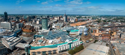 Photo of panoramic view along Brighton Beachfront with the promenade and Ferris Wheel backed by highrise buildings, UK.