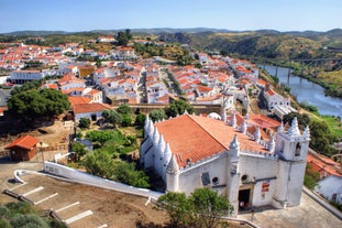 Photo of aerial view over People Crowd Having Fun On Beach And Over Cascais City In Portugal.