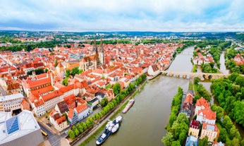 Photo of scenic summer view of the German traditional medieval half-timbered Old Town architecture and bridge over Pegnitz river in Nuremberg, Germany.