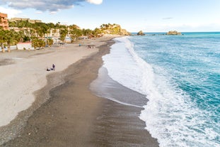 Photo of aerial view of the town of Nerja with the beautiful beach, Málaga, one of the white villages of Andalusia, Spain.