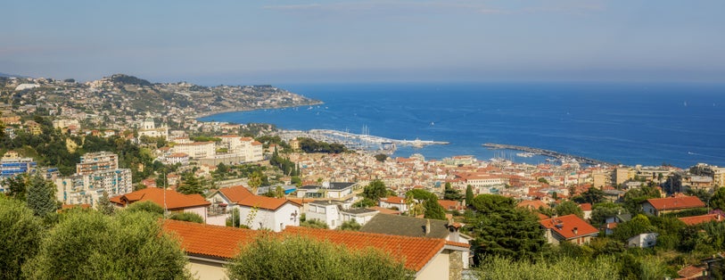 Panoramic view of Sanremo City, Liguria, Italy showing old town "La Pigna", old port and new port and el Santuario Madonna Della Costa.