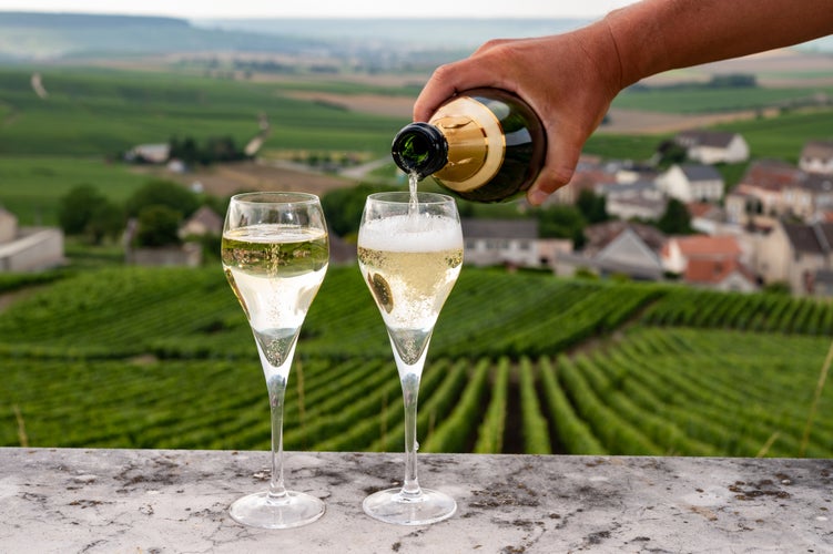 flute glasses with view on green Champagne vineyards, France.jpg