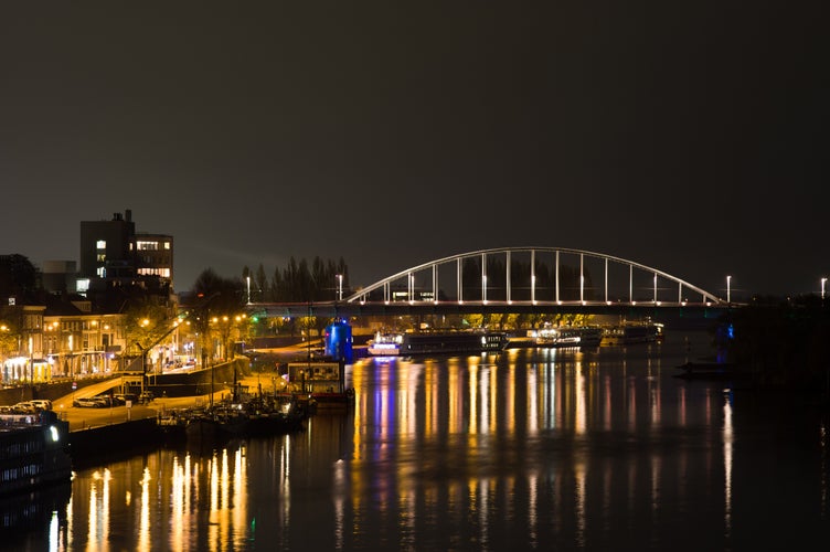 Arnhem in the Netherlands, with the John Frost bridge at night with in the foreground the river Rhine