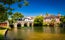 Photo of a stone bridge spans the River Avon, Christchurch, Dorset, England on a hot summer day.