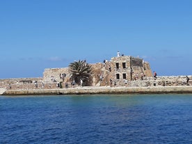 Photo of aerial view of Chania with the amazing lighthouse, mosque, venetian shipyards, Crete, Greece.