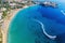 Photo of aerial panoramic beautiful view of Coral bay beach with jet ski and people having fun, Cyprus.