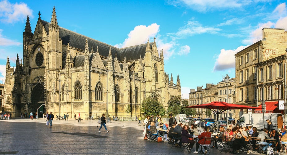 People dining outdoors near Saint-André Cathedral in Bordeaux in September under sunny skies..jpg