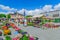 Photo of Scene of Kuopio Market Square, with stalls, the town hall, locals and visitors, in Kuopio, Finland.