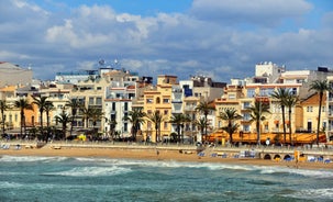 Photo of Sand beach and historical Old Town in mediterranean resort Sitges near Barcelona, Costa Dorada, Catalonia, Spain.