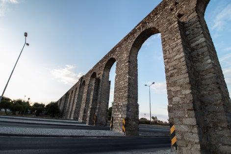 Água de Prata aqueduct on a road  in the city of Evora - Portugal