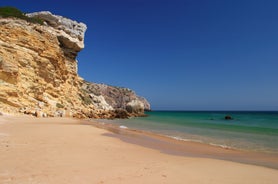 Photo of aerial view of beautiful lighthouse located on high cliffs of Saint Vincent cape in Sagres, Algarve, Portugal.