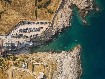 photo of  view ofAerial view of Cala Port'Alga near Torre Incina and Isola dell'Eremita in Polignano a Mare, in Puglia. Drone view of cliffs, coastline in Puglia and small island, near Monopoli, province of Bari.,Polignano a Mare Italy.