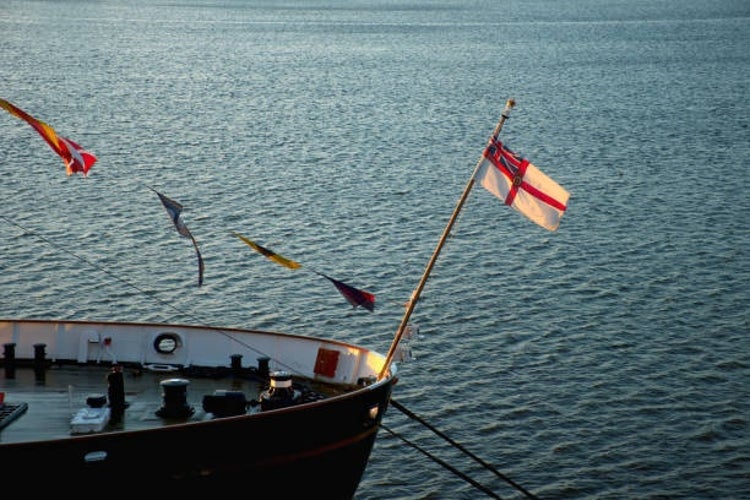 The flag of the Royal Yacht Squadron, featuring a white ensign with a red St. George’s cross and a Union Jack in the upper left corner.jpg