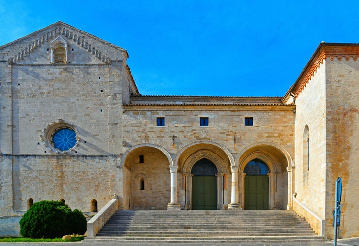 Photo of facade with arches, columns, doors and stone steps of historical cathedral of San Leopardo, Osimo, Ancona, Marche, Italy.