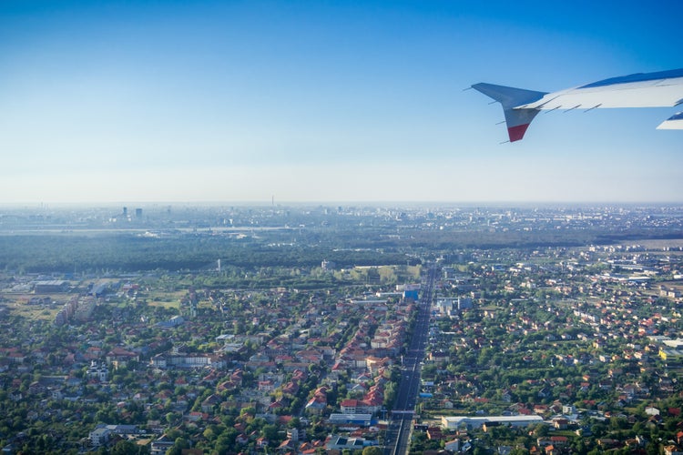 photo off view of Taking off from Otopeni airport; flying over residential neighborhoods, Bucharest skyline in the background; Romania