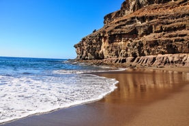 photo of landscape with Maspalomas town and golden sand dunes at sunrise, Gran Canaria, Canary Islands, Spain.